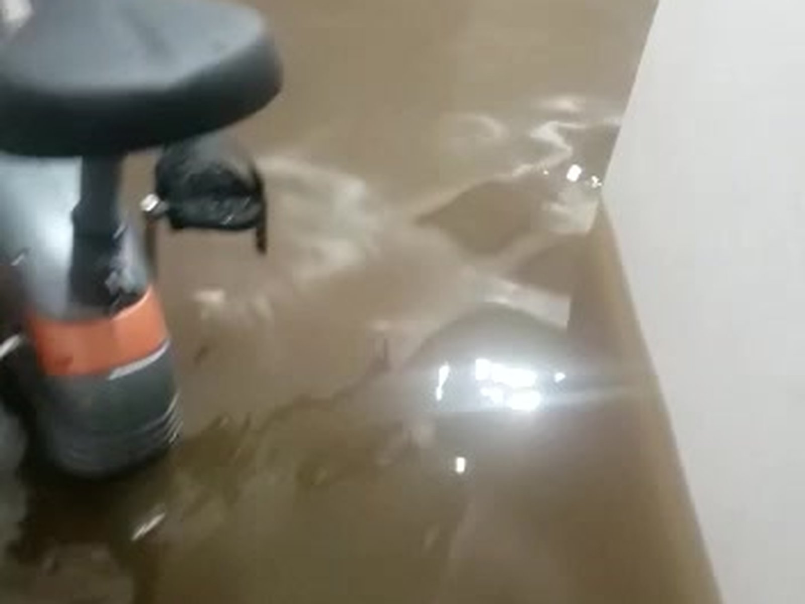 Cat 2 sump pump failure water damage submerging child's scooter on Staten Island finished basement hallway