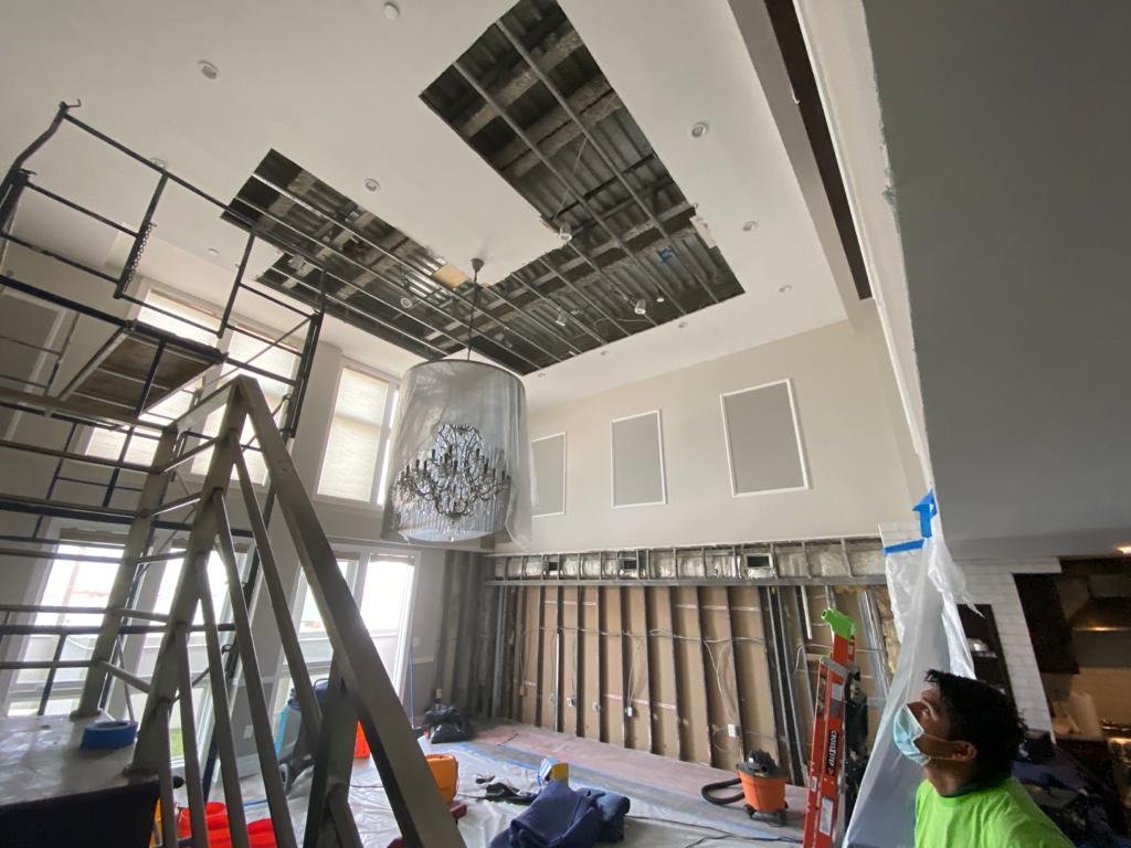 Vapor-barrier-wrapped chandelier protected during ceiling demolition at a Staten Island residence