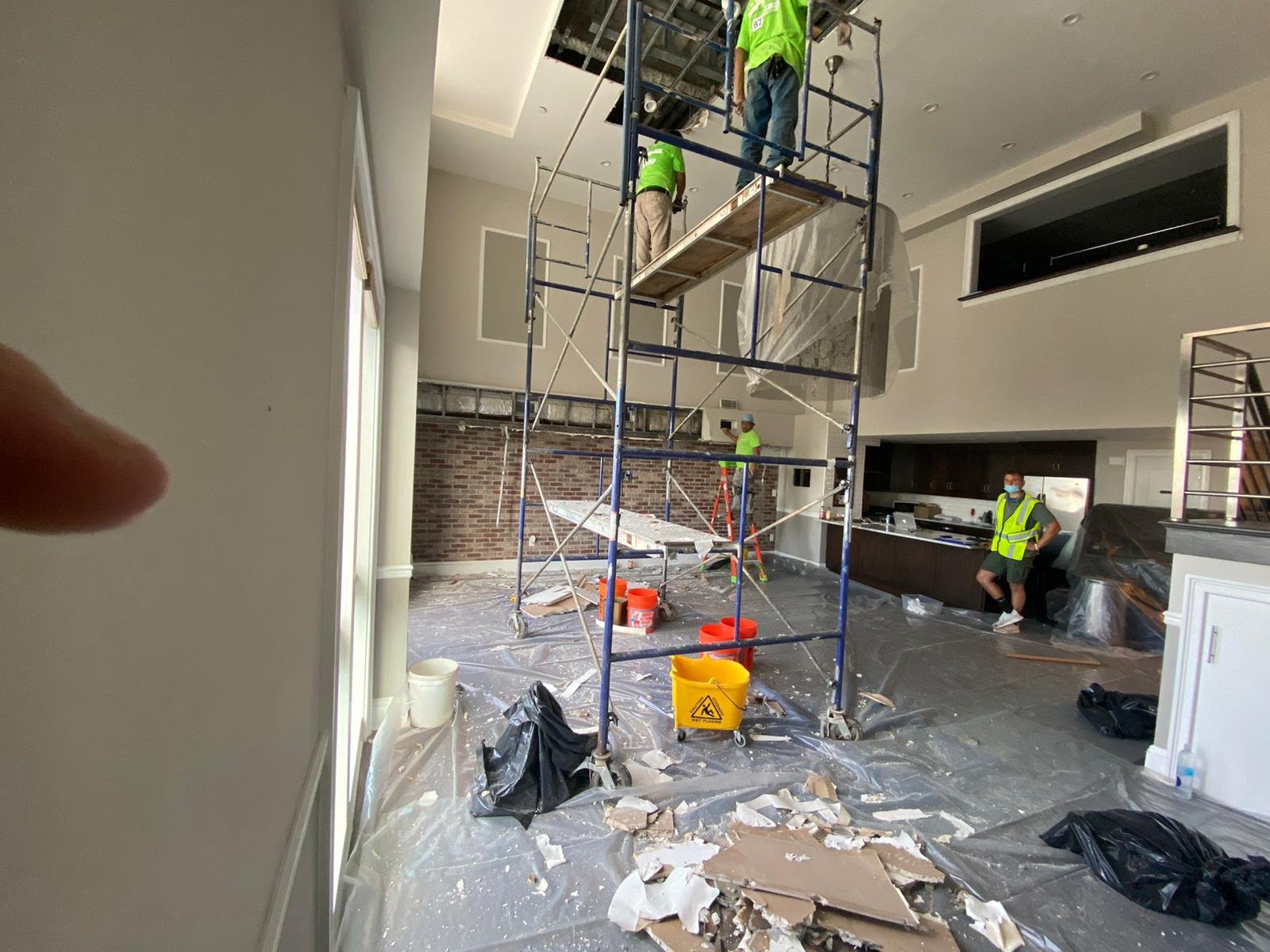 Anajur Construction crew reviewing the scope of damage on-site with a homeowner's insurance adjuster at a Staten Island restoration job